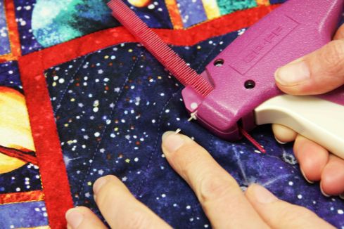 Take a small "stitch" with the needle of the basting gun