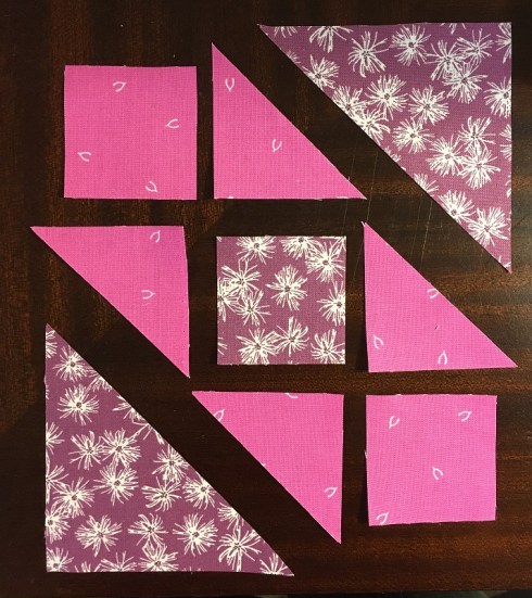 The squares and small triangles form 3 rows of 3