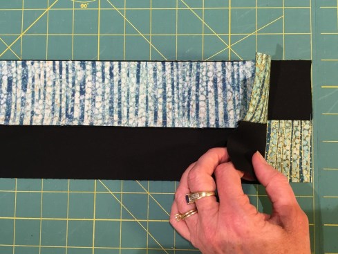 Stack 2 strip sets light-on-dark and dark-on-light to cut the pieces for the 4-patch units