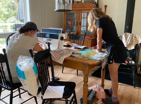 Sherry and Jo cutting and sewing their pillow covers